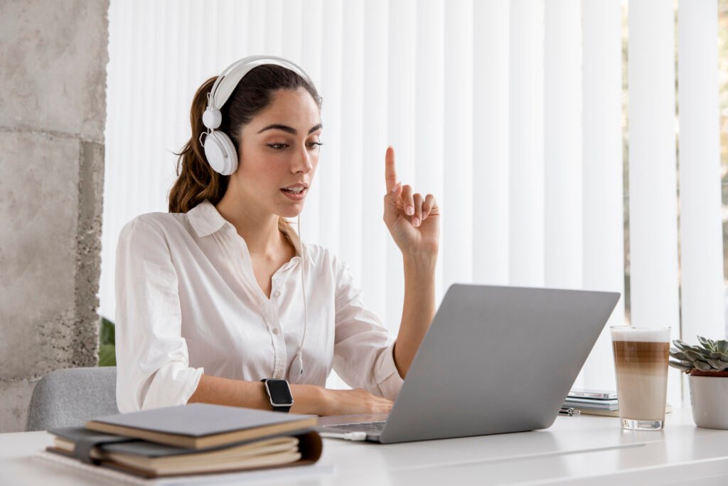 side view businesswoman working with headphones laptop