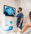 dental-clinic-worker-showing-x-ray-2023-11-27-05-23-40-utc-1